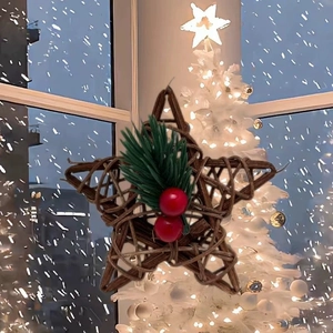 Handmade rattan star ornament with pine needles and red berries for Christmas tree