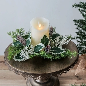 Christmas candle ring with red berries, pine cones and LED candle on metal stand