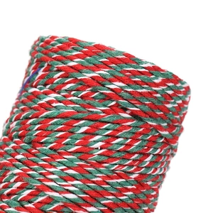 Macro detail of red green and white cotton twine roll for Christmas gift wrapping
