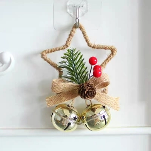 Christmas star ornament with pine cones, berries, and hanging gold bells on white background