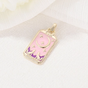 Gold tarot card pendant XVIII THE MOON with pink enamel and wolf motifs on beige fabric