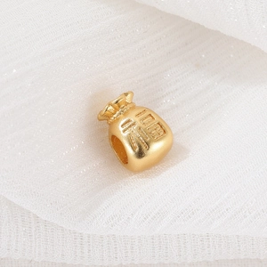 Close-up of golden fortune bag charm with FU character for DIY jewelry making