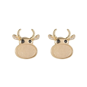 Golden ox head cufflinks with sparkling zircon inlay and black stone eyes on white backdrop