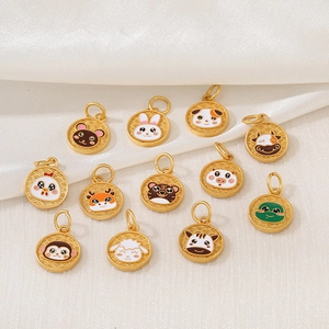 Set of 12 gold zodiac charms with colorful enamel cartoon animals on white silk