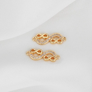 Detail of gold-plated infinity connectors with white zircons for jewelry making