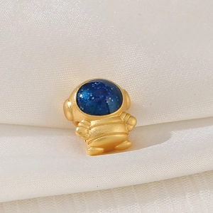 Detailed macro view of a gold astronaut charm with a sparkling blue starry sky visor finish