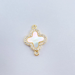 Detailed view of gold clover pendant with mother of pearl inlay and crystal edges