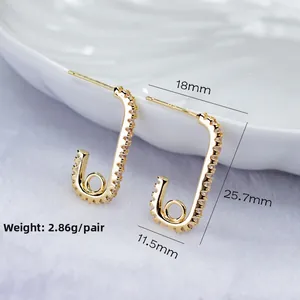 Gold safety pin earrings with cubic zirconia accents, minimalist jewelry for women