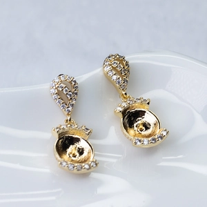 Close-up of gold 925 silver needle pearl earring base with micro-pave cubic zirconia