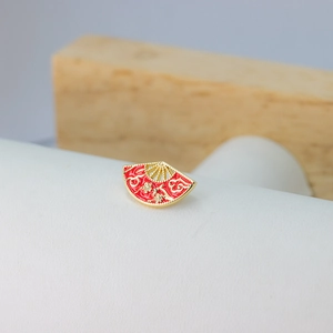 Baroque red fan jewelry with golden plum blossom and lucky cloud pattern in macro view