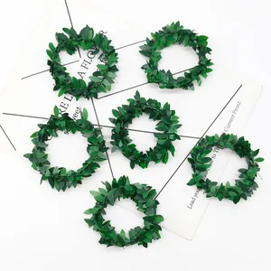 Set of 6 green artificial leaf napkin rings displayed on a white decorative card background
