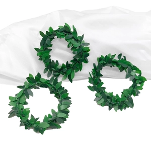 Macro detail of artificial green leaf napkin rings showing realistic foliage texture