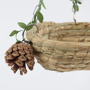 Handwoven straw bird nest hammock with hanging pine cone and metal chain for pet birds