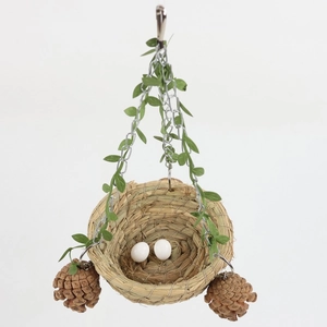 Hanging woven grass bird nest with metal chain, decorative pine cones and artificial vine