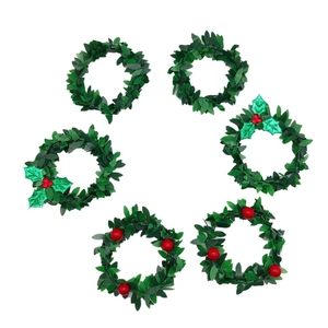 Set of 6 Christmas napkin rings with green artificial leaves and red berry decorations