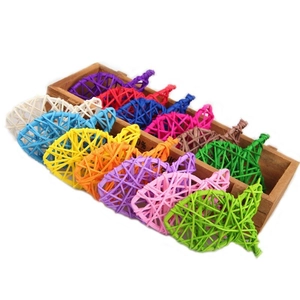 Macro detail of colorful natural woven rattan fish pet toys in a wooden box display