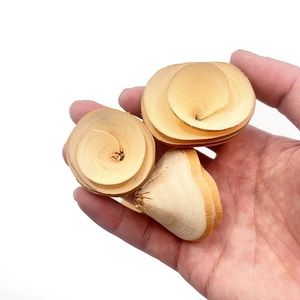 Natural wood curls for hamster chewing and bird training, shown in hand for scale
