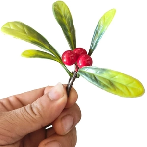 Artificial red berries with textured green magnolia leaves for Christmas gift box decor
