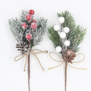 Detail of festive artificial pine picks with frosted berries and natural pinecones