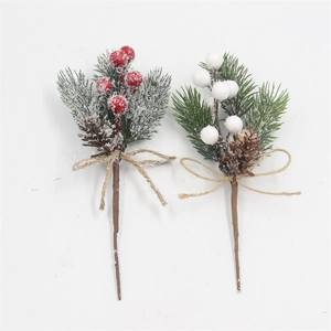 Detail of Christmas pine branch with artificial berries and snow frosted pine needles