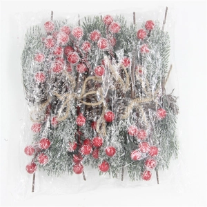 Close-up of artificial red berries and pine needles with snow effect and hemp rope ties