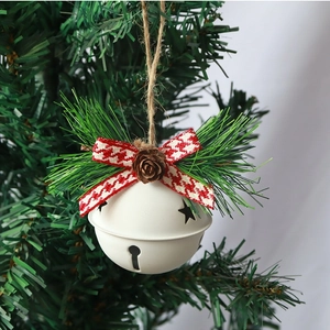 White Christmas bell ornament with pine cone and red checkered bow hanging on a tree