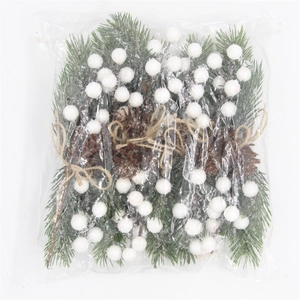 Christmas pine needle branches with berries and cones packed in clear poly bags