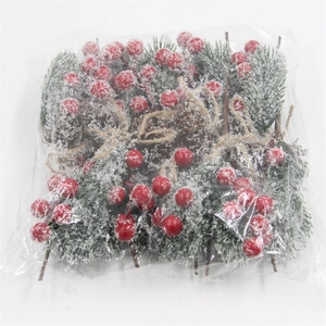 Detail of Christmas artificial bouquet with red berries, pine needles, and pine cones in packaging
