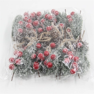 Christmas pine needle bundle with red berries and snow powder for holiday decoration