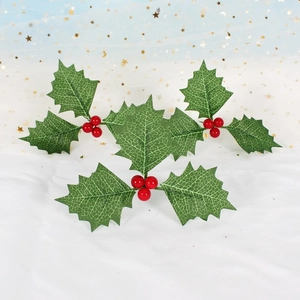 Artificial Christmas holly berries with green leaves and red fruit for festive decoration