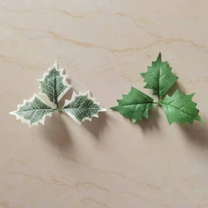 Set of two artificial Christmas holly leaves in variegated white and solid green colors