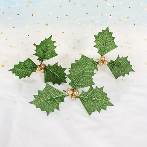 Artificial Christmas holly leaves with golden berries for holiday decoration and craft DIY