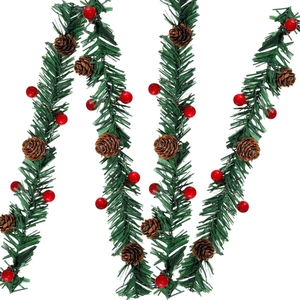 Christmas garland with red berries and pine cones for holiday staircase and door decoration