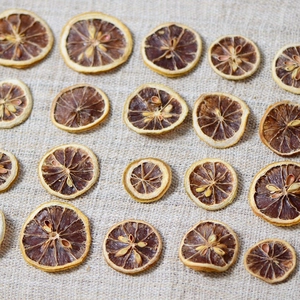 Dried lemon slices for aromatherapy candle making and floral crafts on linen fabric