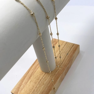 Minimalist 14k gold plated copper bead chain necklace displayed on a T-bar stand
