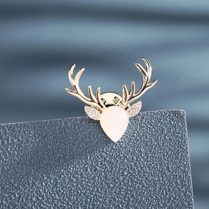 Elegant vintage gold stag antler brooch with opal stone and zircon on blue card