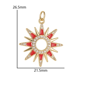 Macro view of 14K gold sun pendant with red enamel and zircon pavé detailing