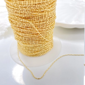 Macro shot of 14K gold plated rice bead chain roll for DIY jewelry making supplies