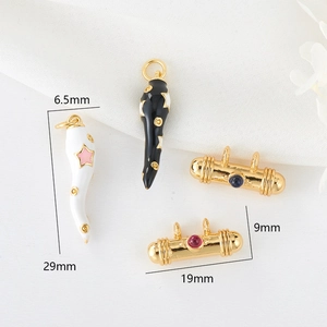 Detail shot of enamel horn charms and gold evil eye beads with exact size measurements