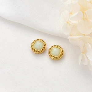 Vintage gold square stud earrings with pale green gemstone and floral filigree frame