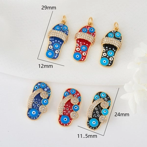 Detailed view of flip-flop evil eye pendants with 14K gold plating and pavé zircon stones