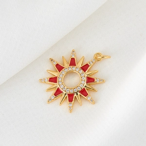 Sparkling sun pendant with red enamel rays and white cubic zirconia in gold plating
