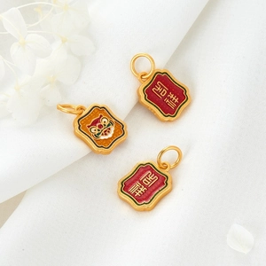 Detail of gold enamel tiger pendants with traditional Chinese auspicious motifs