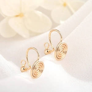 Detailed macro view of 14K gold plated spiral coil ear clips for DIY jewelry making