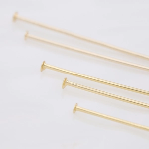 Macro shot of 14K gold plated T-pins in various lengths for DIY jewelry making projects