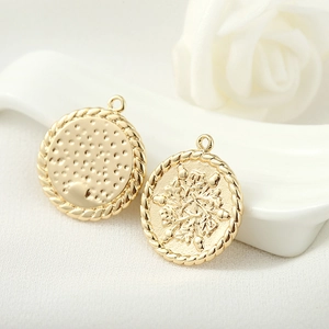 14k gold plated round pendant set with hammered texture and floral relief pattern