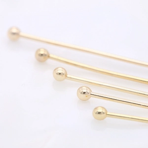Macro detail of 14K gold plated ball head pins for jewelry making and DIY crafts