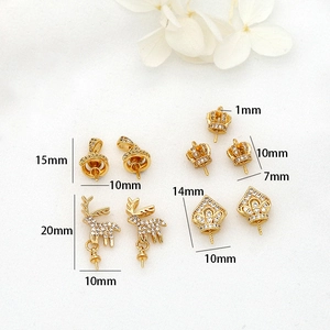 Detailed views of 14K gold plated crown and bell pendants with zircon for DIY pearl jewelry
