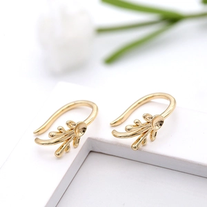 Leaf shaped 14K gold plated earring clips for jewelry making on white display steps