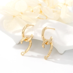 Minimalist 14K gold plated S925 silver needle twisted earrings on white ceramic tray